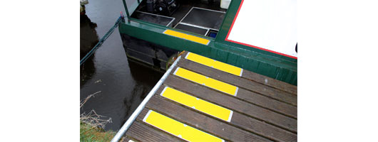 Yellow bolt down plates on decking B