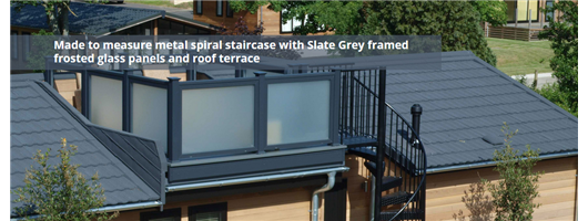 Made to measure metal spiral staircase with Slate Grey framed frosted glass panels and roof terrace