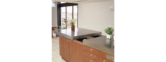 Large stainless steel island worktop with special sliding section to reveal additional storage