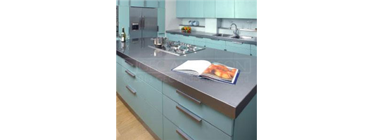 Domestic kitchen with stainless steel island top with cut out for hob and deep edge profile