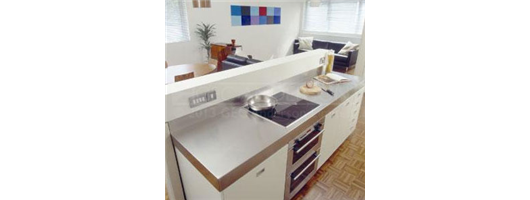 Stainless steel worktop with cut out for hob, deep edge profiles and integrated back upstand