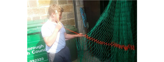 Trawl net making (my nephew learning how to use a needle) 