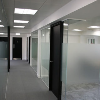 Hallway in Office with Each Room Separated by Glass Walls