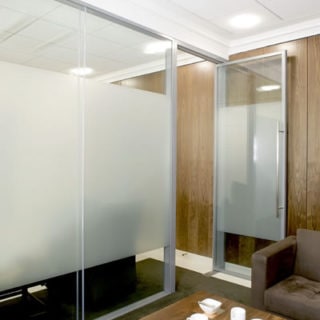Glass Walls & Glass Door Separating a Lounge Area from the rest of the Working Area