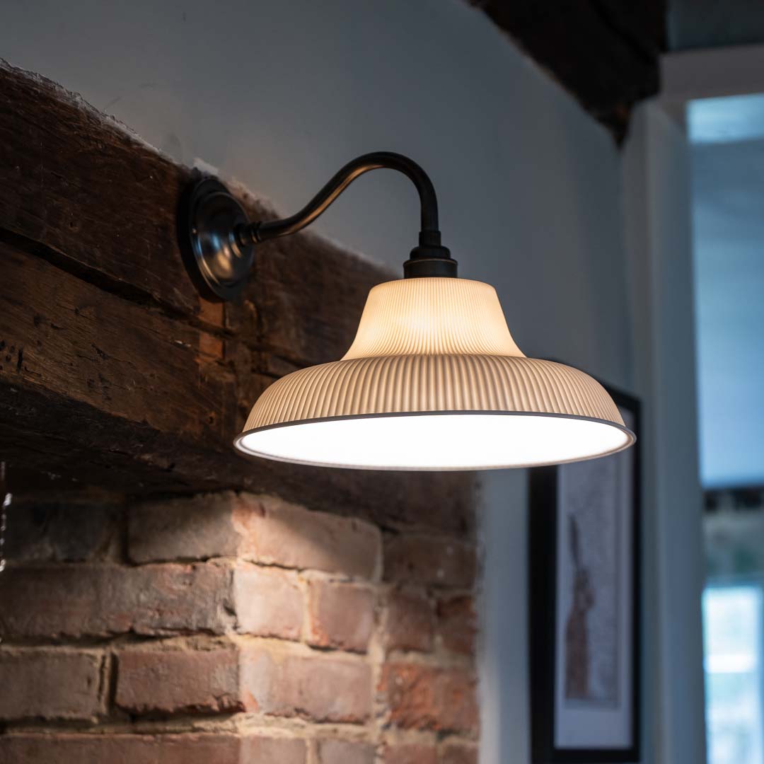 Hartington Ceramic Shade Wall Light on a rustic brick fireplace