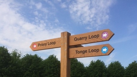 Oak finger post or orientation post with directional arms.  Text routed into the finger blades which are moticed into the posts.  Shelley Signs.