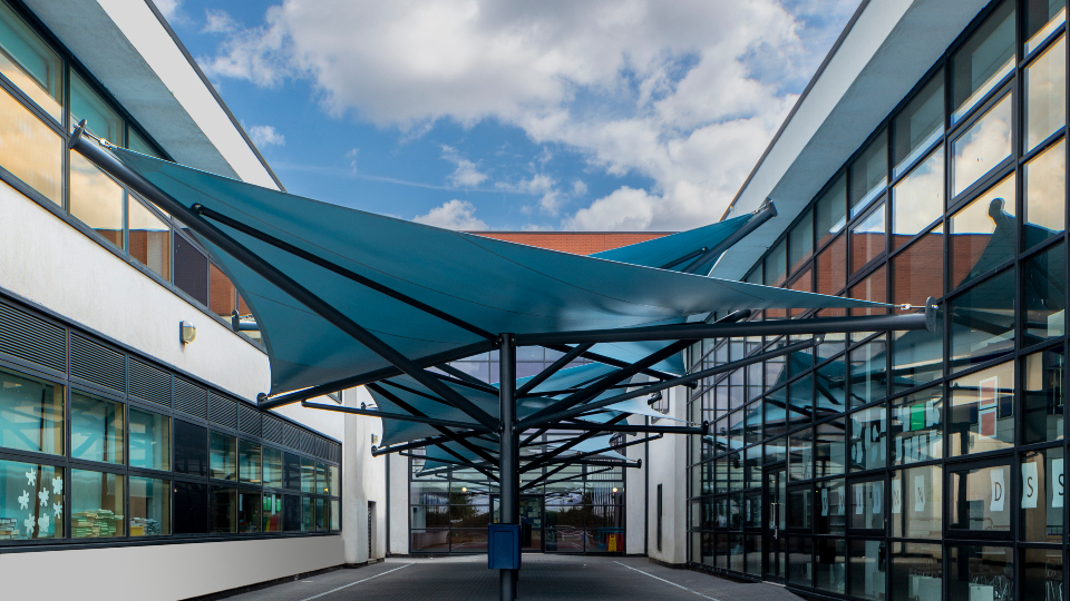 Modern A&S Landscape fabric tensile canopies adding striking covered spaces for schools.