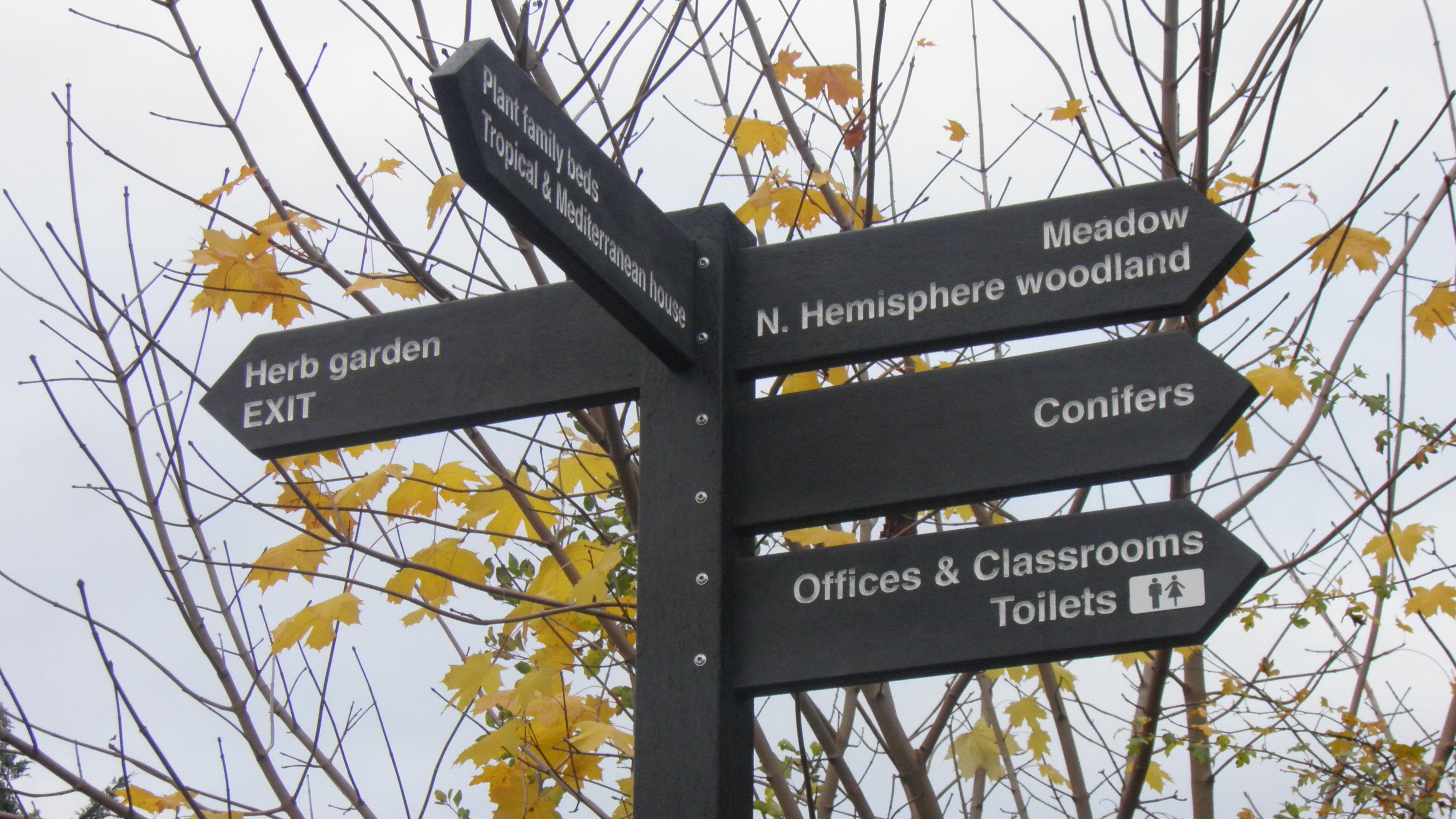 Directional finger post produced in black recycled plastic.  Text routed or indented into the finger arms, painted with arms morticed into the posts