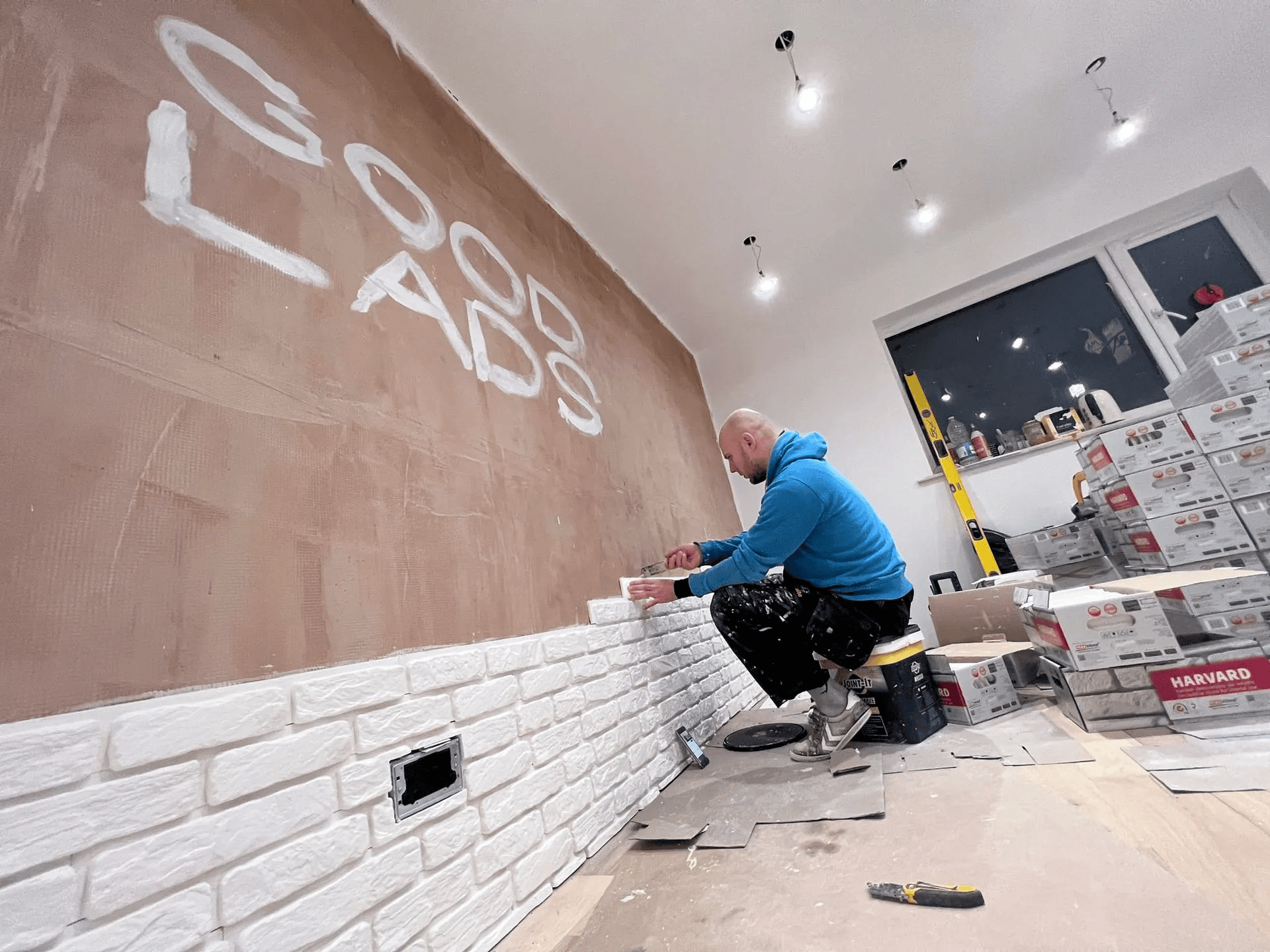Tiler installing brick tiles