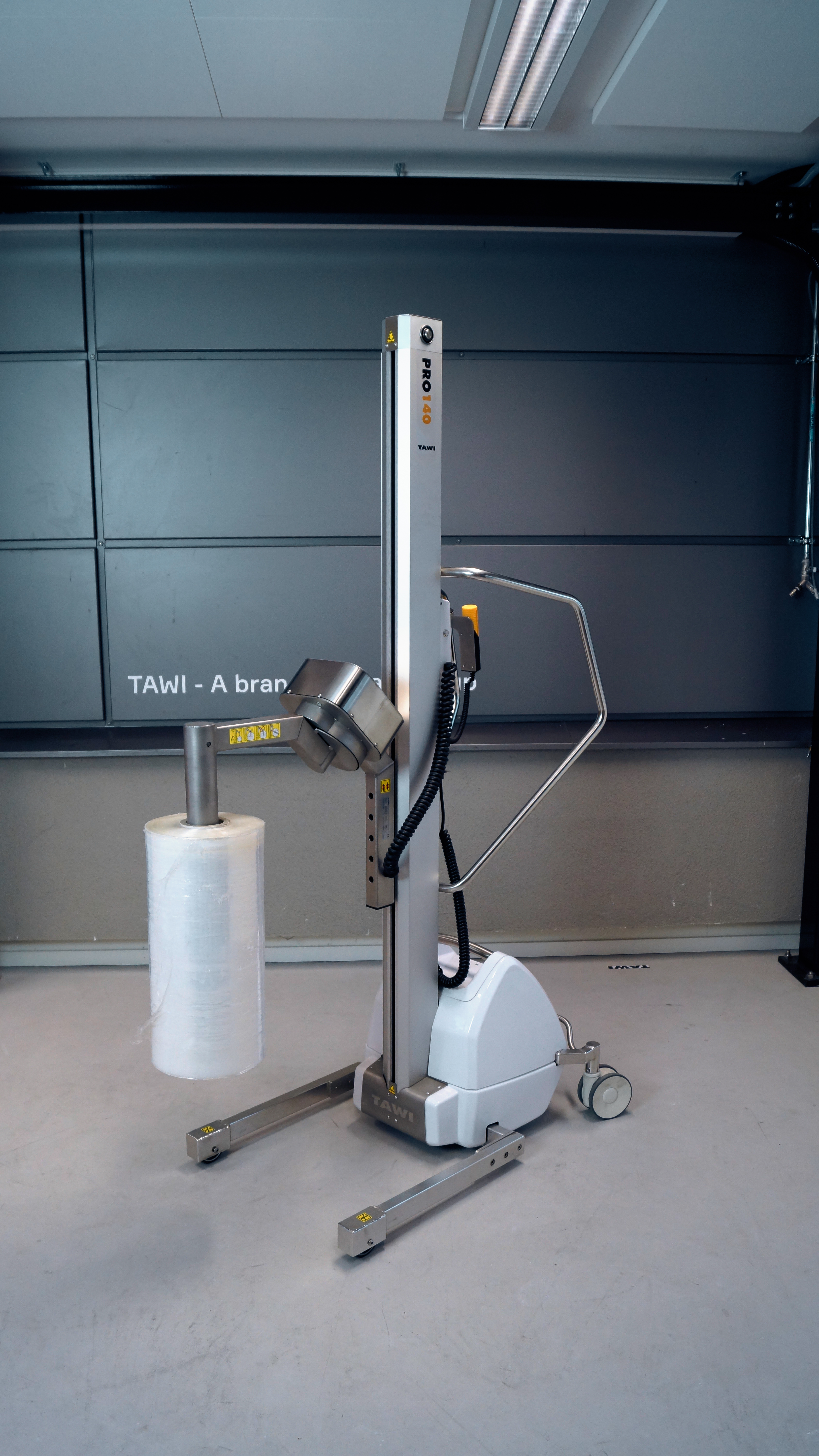 stainless steel lifting trolley carrying a reel