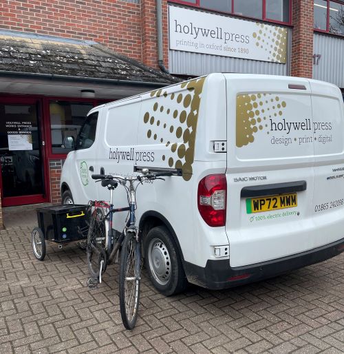 Holywell's all-electric van and delivery bike parked outside the factory in Oxford.