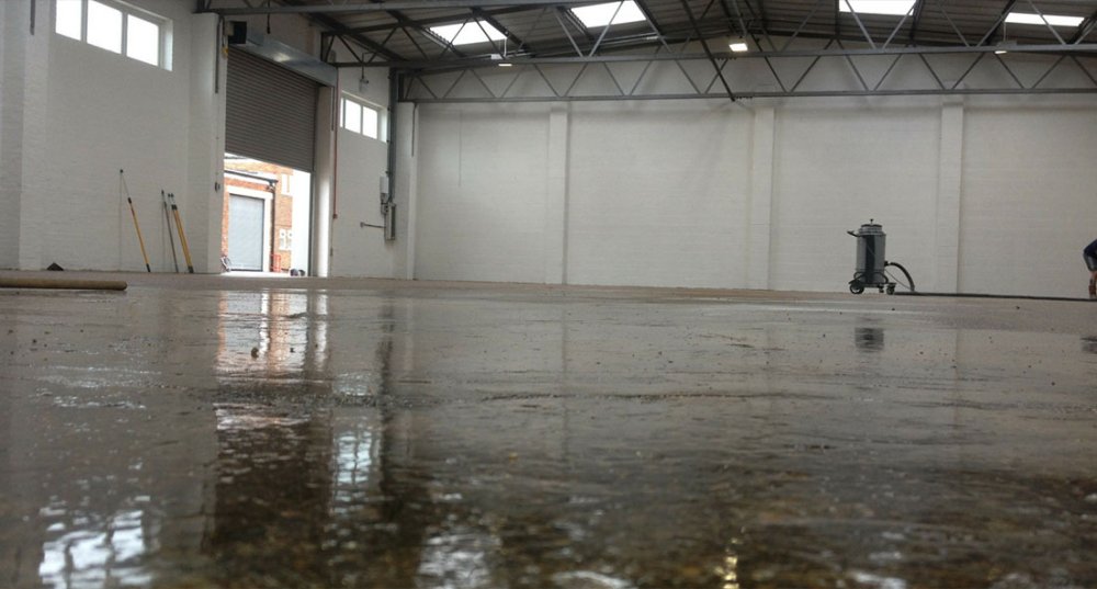 A warehouse floor with epoxy resin clear primer on