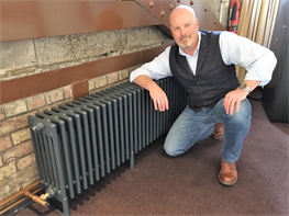 Mike Fenwick, proudly showing off one of the radiators inside Tower Bridge.