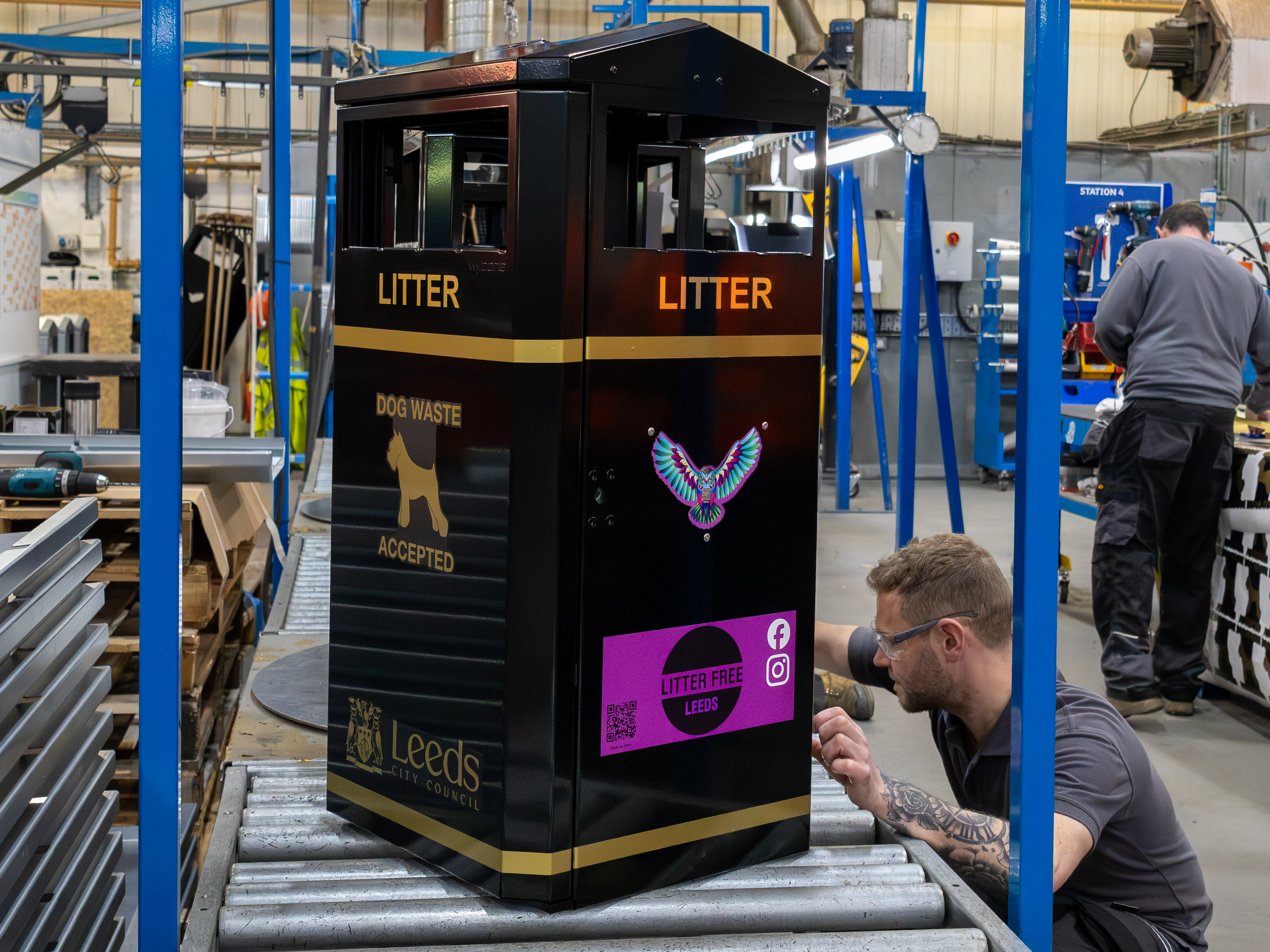 Bespoke MLB/112 Eco litter bin manufactured by Wybone for Leeds City Council, featuring black and gold powder coating, a laser-cut Swoopy the Owl emblem, custom graphics and dual waste apertures.