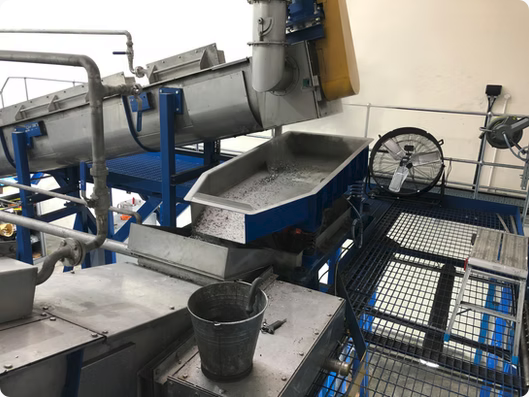 Vibrating Feers for Shaved Metal Handling