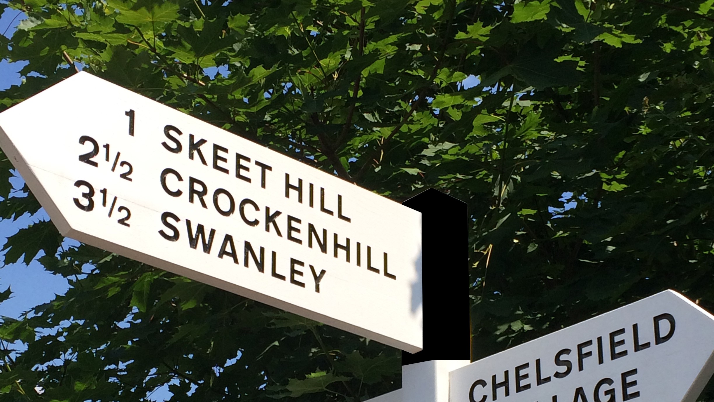 Village directional sign or finger post produced in treated softwood, painted black and white in a heritage style.  Design by Shelley Signs.