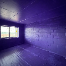 Passive Purple airtight membrane applied to blockwork walls and ceiling on site