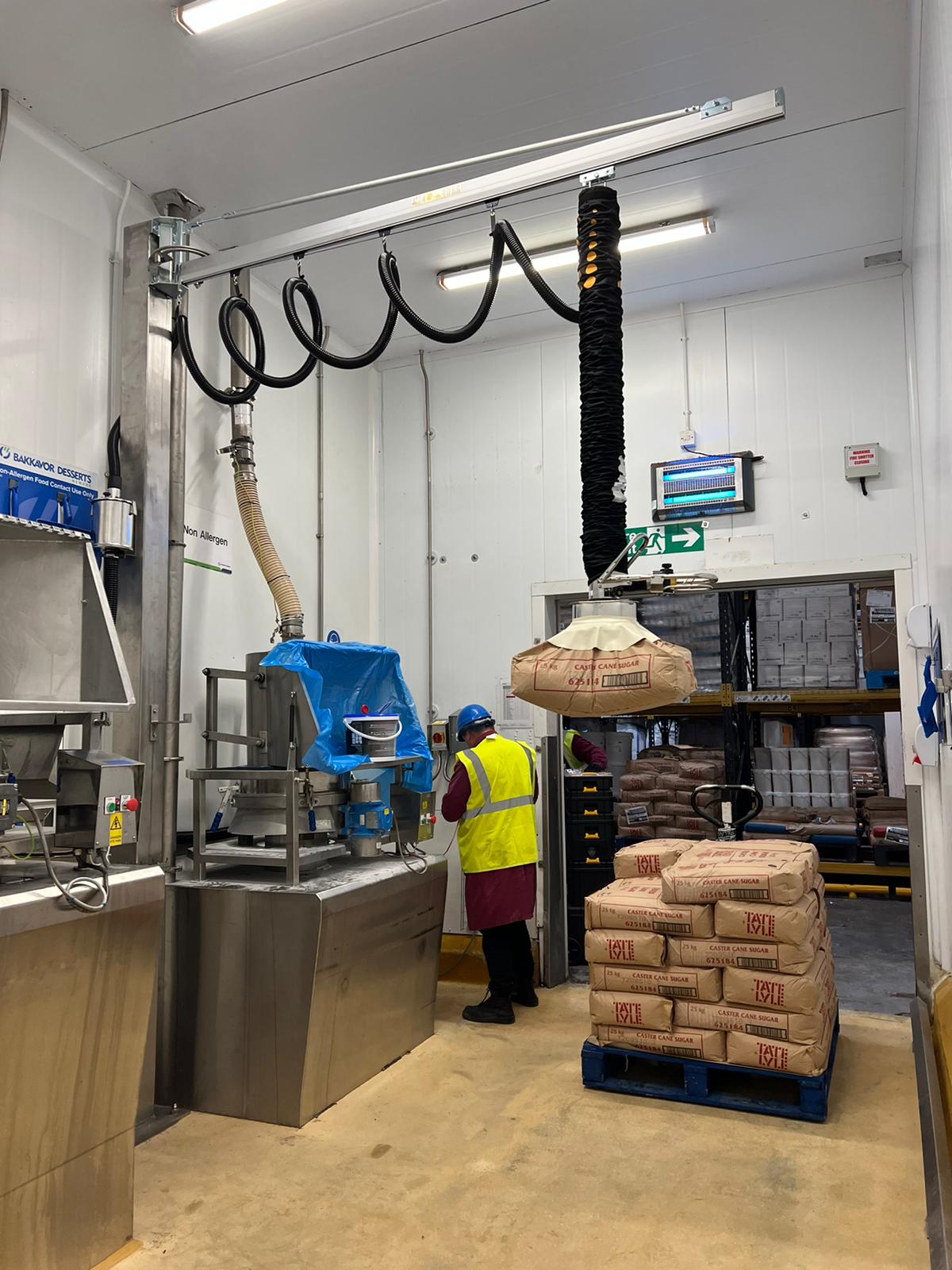 paper bags in a factory being vacuum lifted